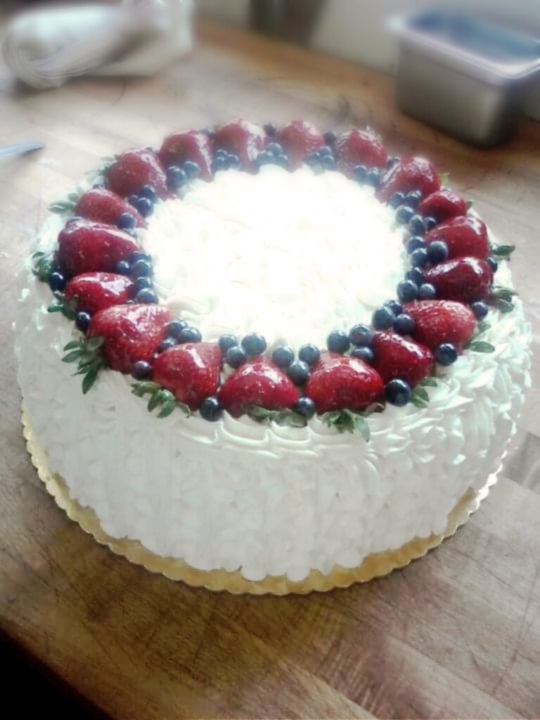 White cake topped with fresh berries