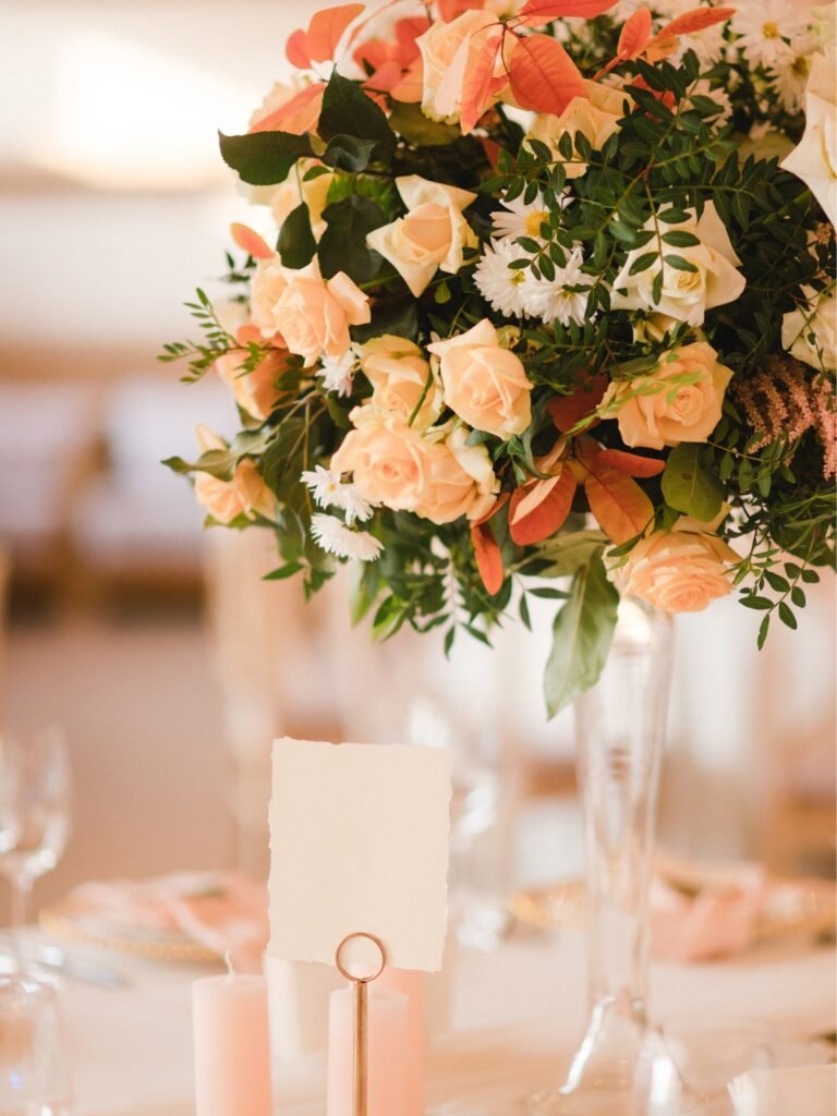Table vignette with peach colored flowers